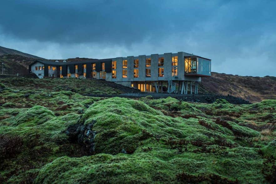 ION Adventure Hotel near Thingvellir National Park in Iceland surrounded by mossy lava fields at dusk.