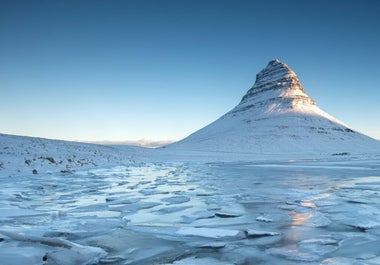 Snow envelops the Kirkjufell mountain.