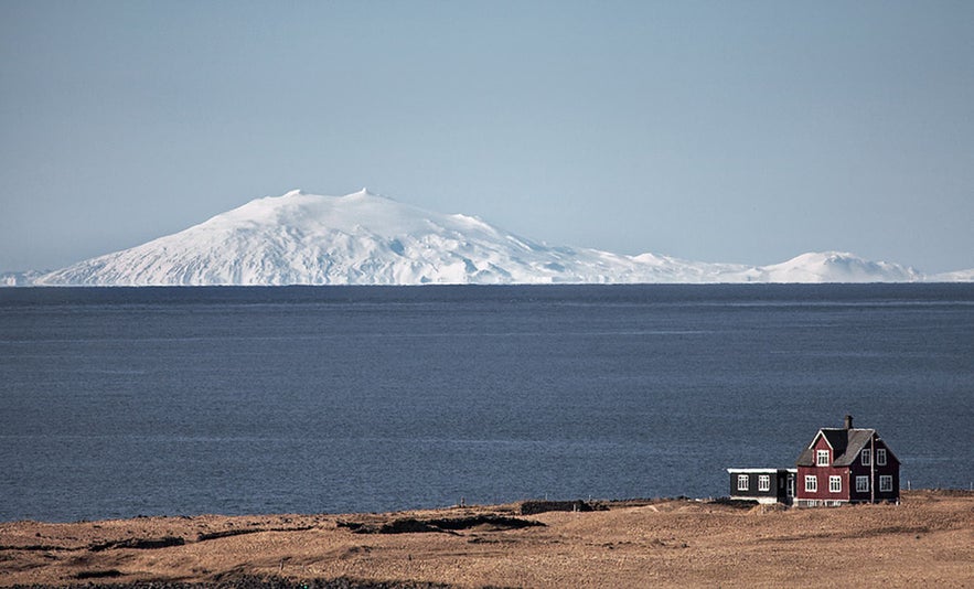 View of the snow-covered Snaefellsjokull Glacier and Volcano seen from the coast of the Snaefellsnes Peninsula in West Iceland.