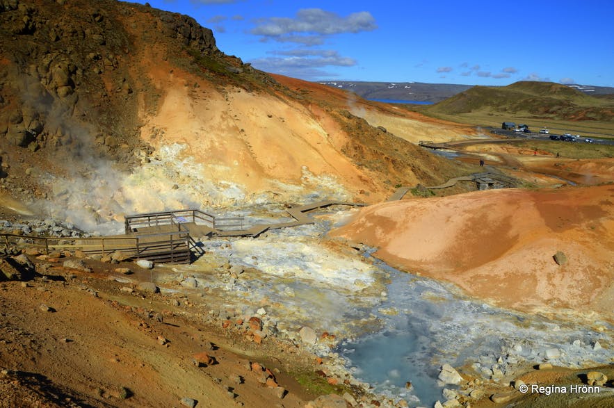 Steam rising on either side of the wooden walkway at Seltún.