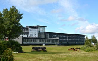 Hótel Selfoss, located on a verdant field of greenery.