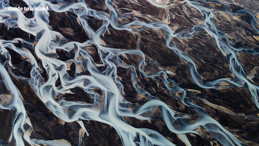 A river network snakes through Iceland, as seen from a helicopter.