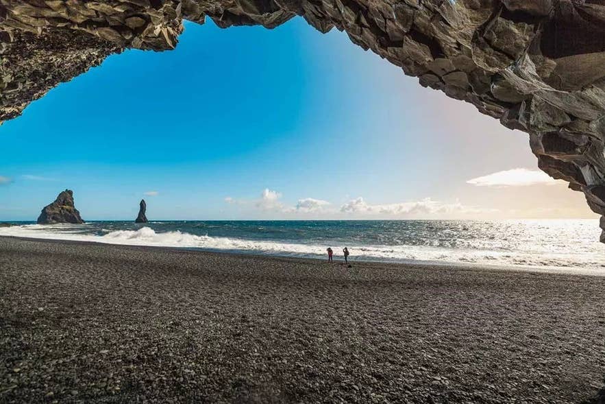 View from inside Reynisfjara's basalt sea cave out to the Reynisdrangar sea stacks