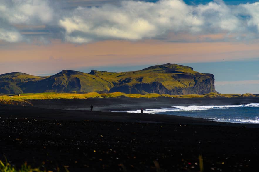 Waves rolling up the black sand shoreline at Reynisfjara in South Iceland
