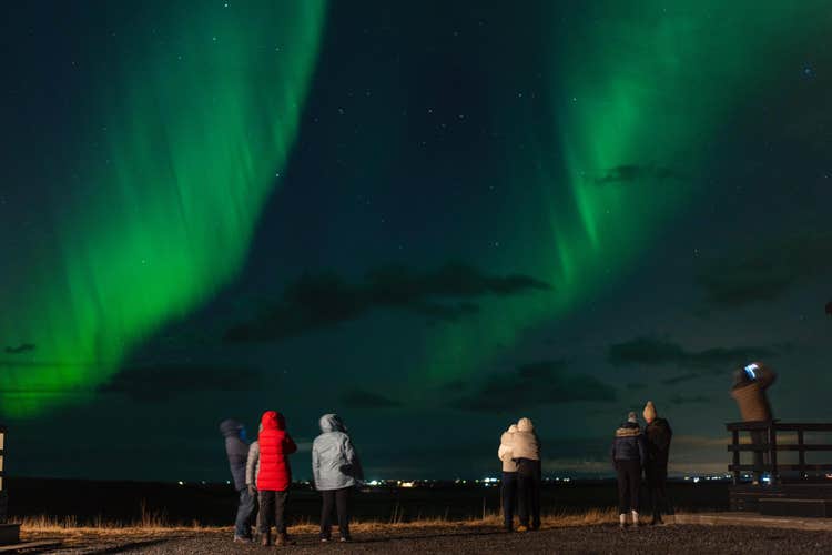 A small group of travelers pictured enjoying this northern lights tour from Reykjavik.