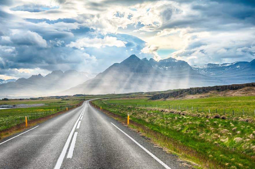 A summer self-drive tour scene in Iceland with open roads and bright skies.