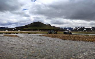 Jeeps cross a river in Landmannalaugar in the Icelandic Highlands.