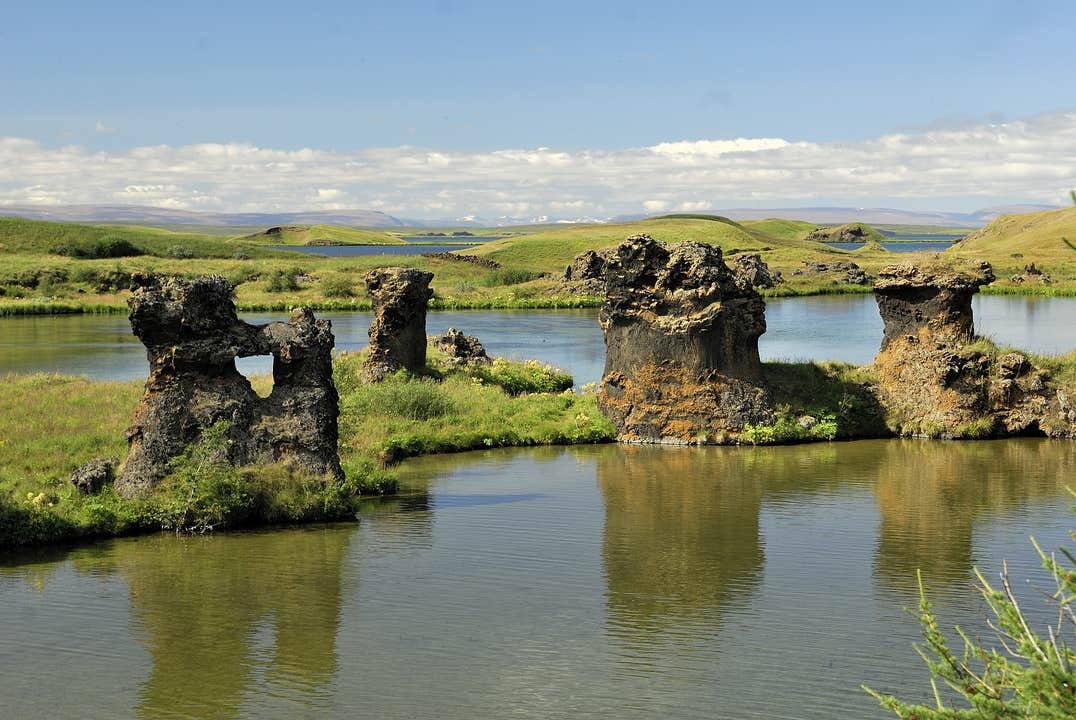 Lava rock formations rising from the water at Lake Myvatn in North Iceland.