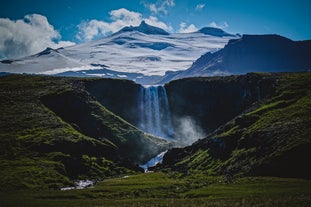 The Snaefellsnes Peninsula towers behind a waterfall.