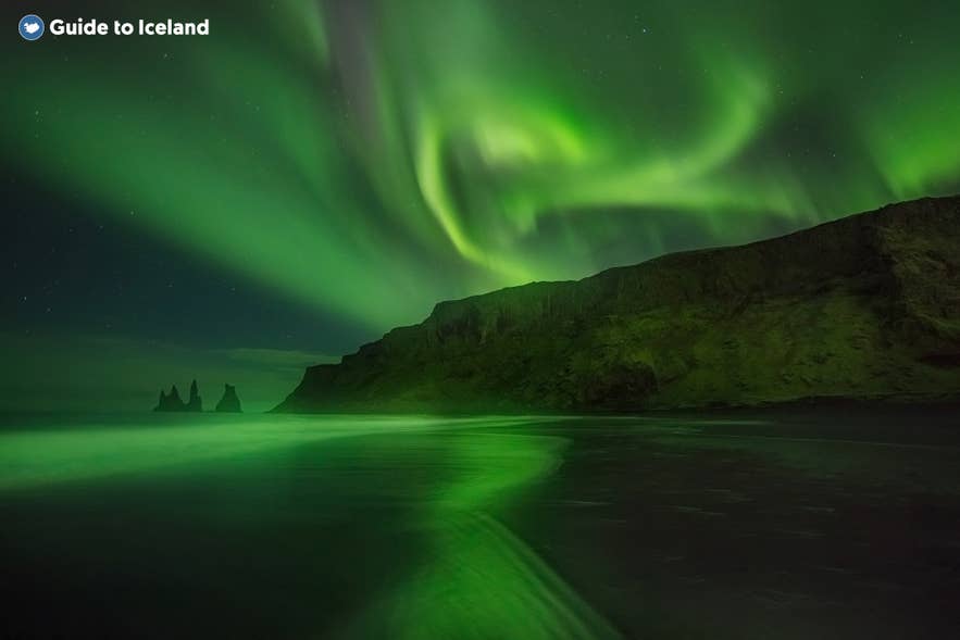 Northern lights over the Reynisdrangar Sea Stacks at Reynisfjara Black Sand Beach in winter