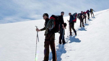 Adventurers in Iceland hiking to the summit of the Eyjafjallajokull volcano.