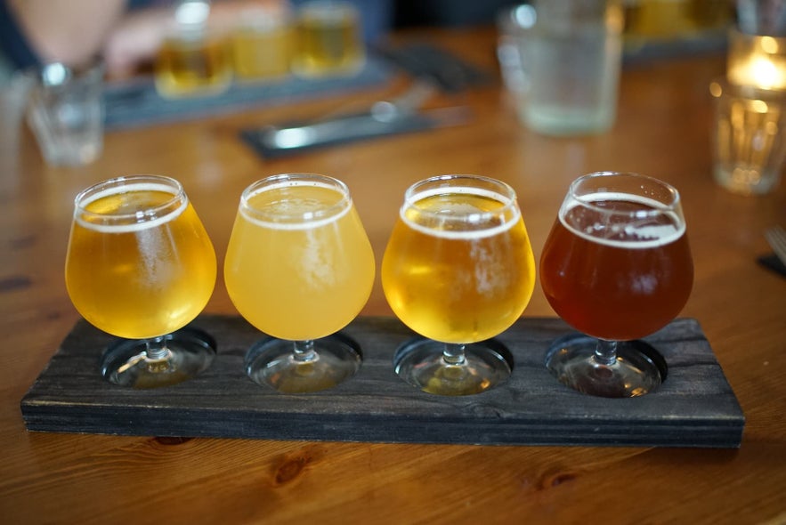 Tasting flight of beers in Iceland served at a Reykjavik craft brewery on a wooden table. Tasting flight of beers in Iceland served at a Reykjavik craft brewery on a wooden table.