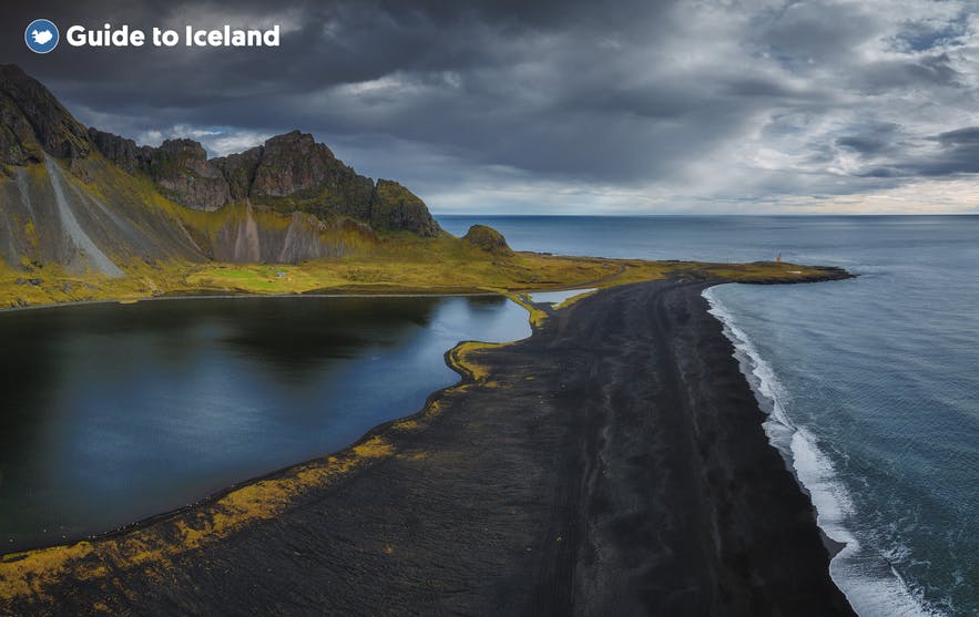 The seas of South Iceland reflect the mountains in the sea.