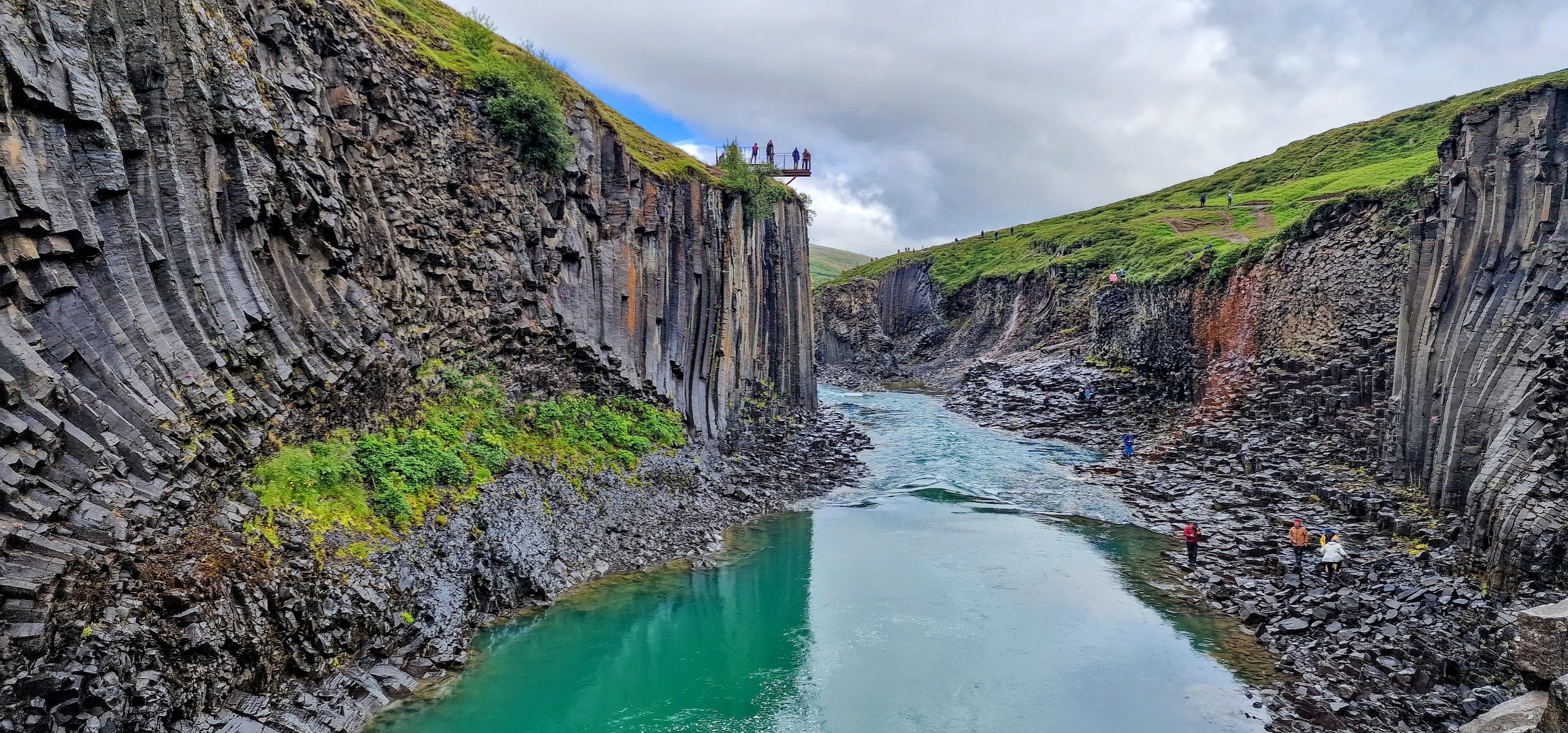 Visitors overlooking Studlagil canyon from an observation deck