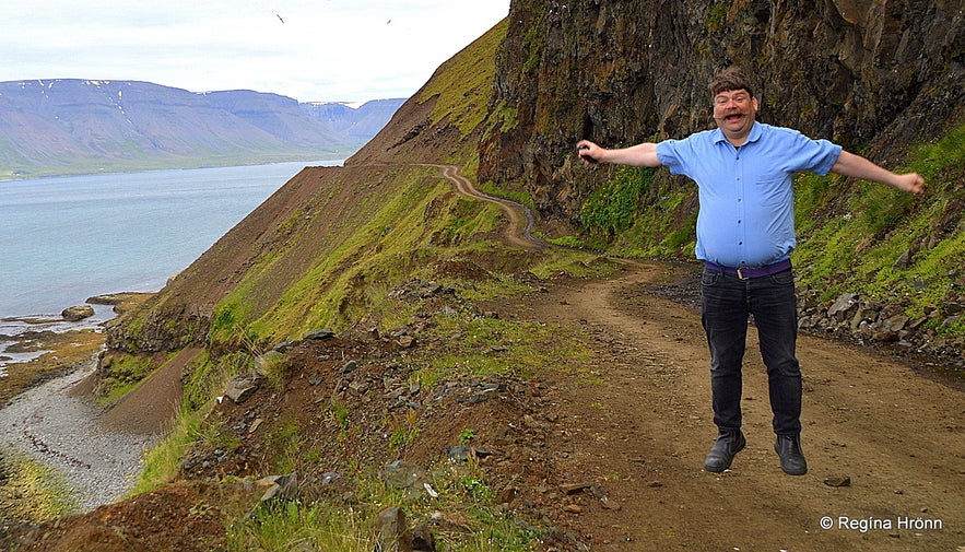 Regína's husband jumping on Kjaranbraut road in the Westfjords