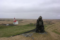 A cairn and church stand at Alftanes.