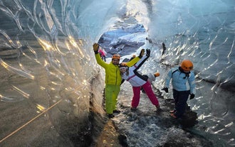 Adventurers happily exploring the Katla ice cave near Vik.