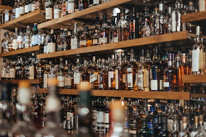 A well-stocked whiskey wall at a Reykjavik bar, one of several lively stops on the guided nightlife tour.