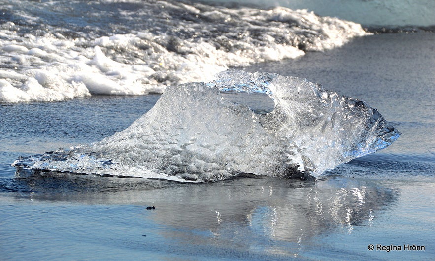 Sparkling ice on the beach by Jökulsárlón