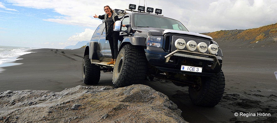 Regína Driving in a super jeep on a black sand beach Regína Driving in a super jeep on a black sand beach