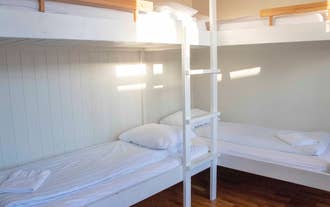 Two sets of bunk beds in a room at 1908 Hostel By Ourhotels.