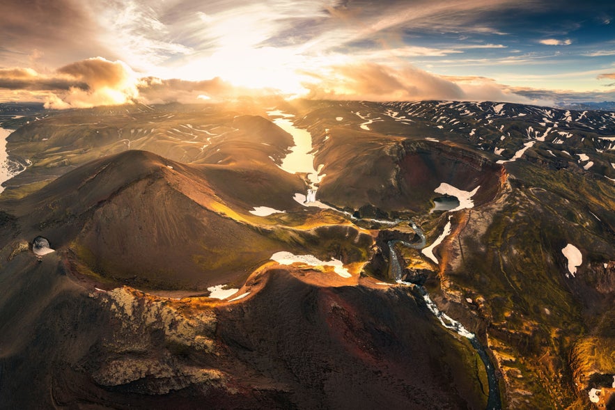 Aerial drone view of sunset over mysterious volcanic crater and glacier stretches through the central highlands of iceland on summer. Rauðibotn, Torfajökull and Mýrdalsjökull glaciers