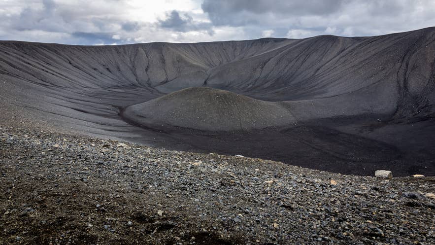 Hverfjall explosion volcano cone, landscape of tephra cone (tuff ring volcano) in northern Iceland with black volcanic rocks.