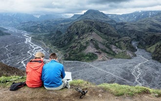 Two hikers in Thorsmork enjoying a rest while surrounded by beautiful landscapes.