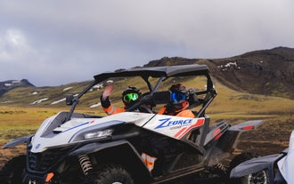 A person waves from the seat of a buggy during a tour in Iceland.