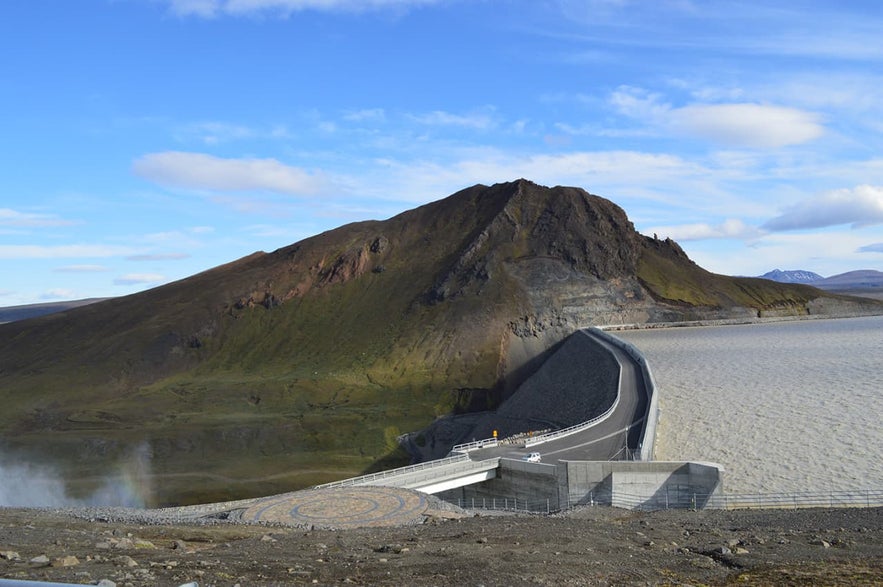 Karahnjukar Dam and Halslon reservoir under blue sky in the East Icelandic Highlands.