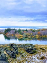 Colorful autumn landscape around Lake Myvatn with calm reflections.