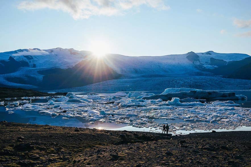 A group of people standing in front of a snowy mountain