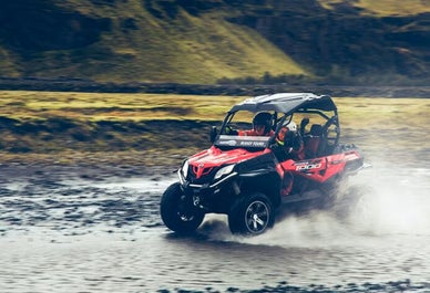 A buggy adventurer crossing a shallow river in Iceland.