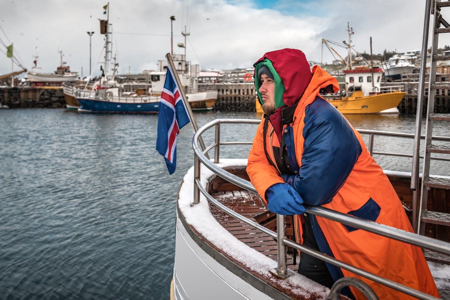 Man on fishing boat during Sjomannadagurinn in Iceland in June, celebrating Seafarers’ Day.