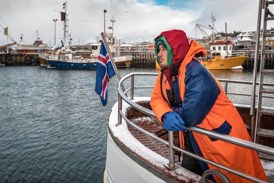 Man on fishing boat during Sjomannadagurinn in Iceland in June, celebrating Seafarers' Day. Man on fishing boat during Sjomannadagurinn in Iceland in June, celebrating Seafarers' Day.