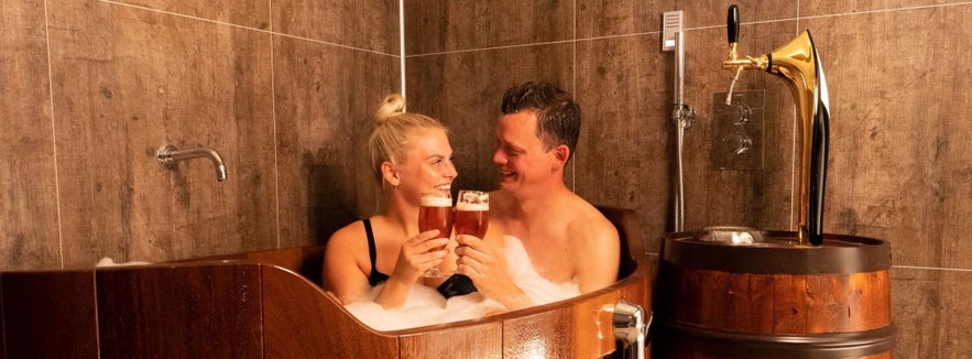 Couple enjoying beers in Iceland at the Kaldi Beer Spa in North Iceland.