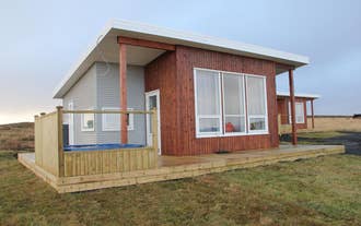 Blue View Cabin with large front windows and wooden porch.