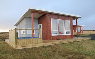Blue View Cabin with large front windows and wooden porch.