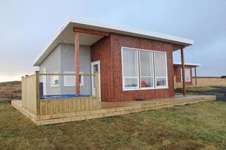 Blue View Cabin with large front windows and wooden porch.