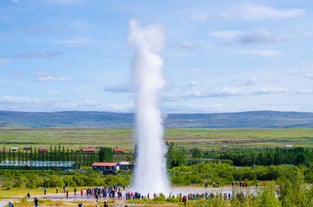 Strokkur Geyser in Iceland erupts to impressive heights.