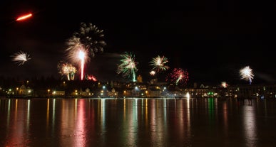 Fireworks bursting over Reykjavik from sea.