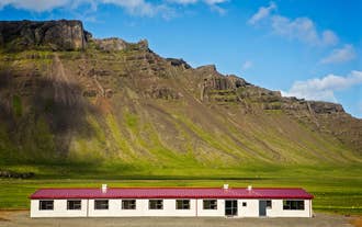 Vagnsstadir HI Hostel sits under a mountain.