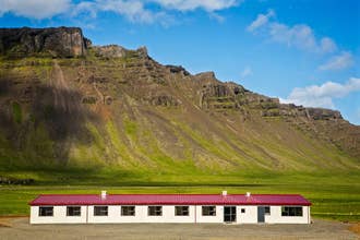 Vagnsstadir HI Hostel sits under a mountain.