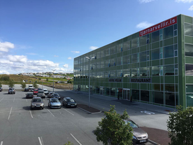 Hotel Vellir is a modern glass building.