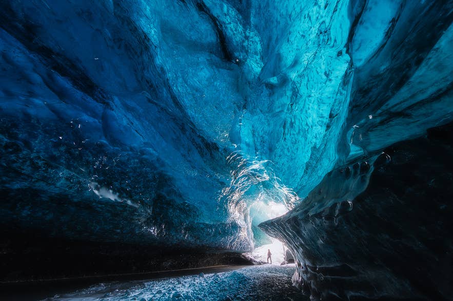 Blue ice cave in Vatnajokull lit from its entrance, visited on Glacier Trips' Crystal Ice Cave exploration tour.