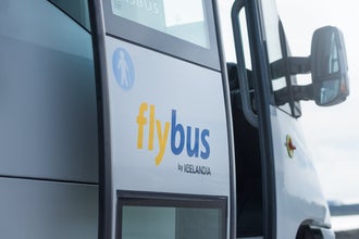 A Flybus parked at Keflavik Airport, offering airport transfers to Reykjavik and other destinations in Iceland.