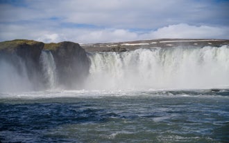 The water of Godafoss waterfall cascades into the river below.
