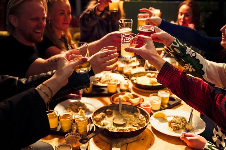Travelers raise a toast over a table laden with local delicacies