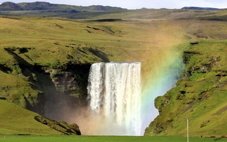 A rainbow conceals Skogafoss in South Iceland.