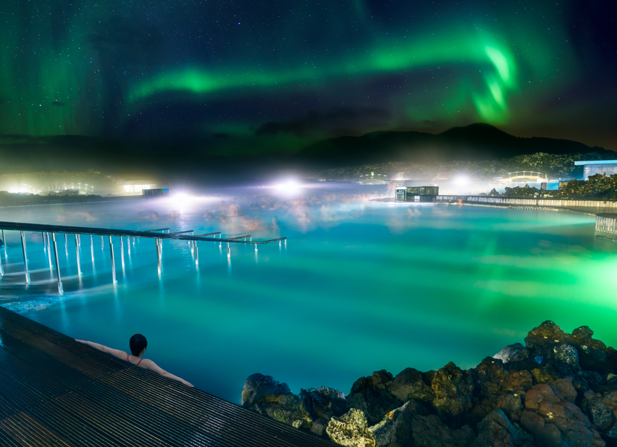 Northern lights dancing over the Blue Lagoon on a winter night, one of the top things to do near Reykjavik in February.